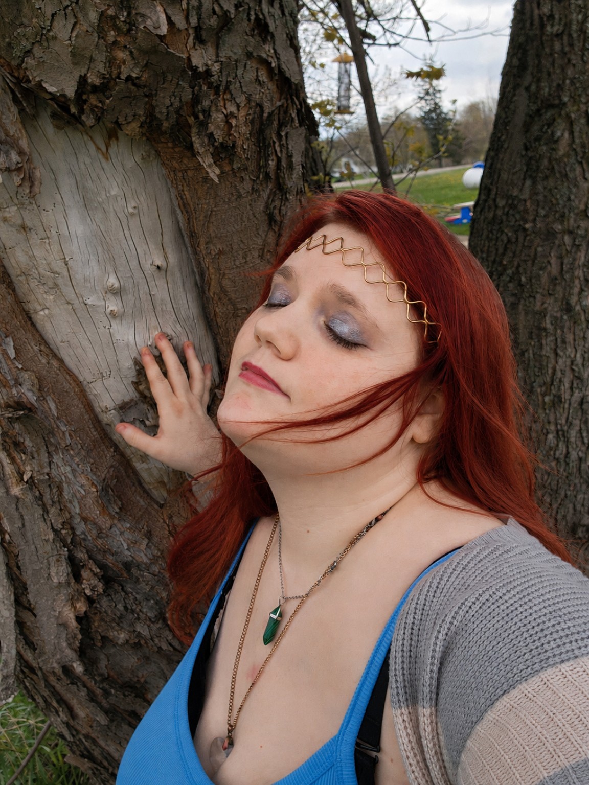 Holley A. Jones beside a tree in a fantasy-inspired portrait